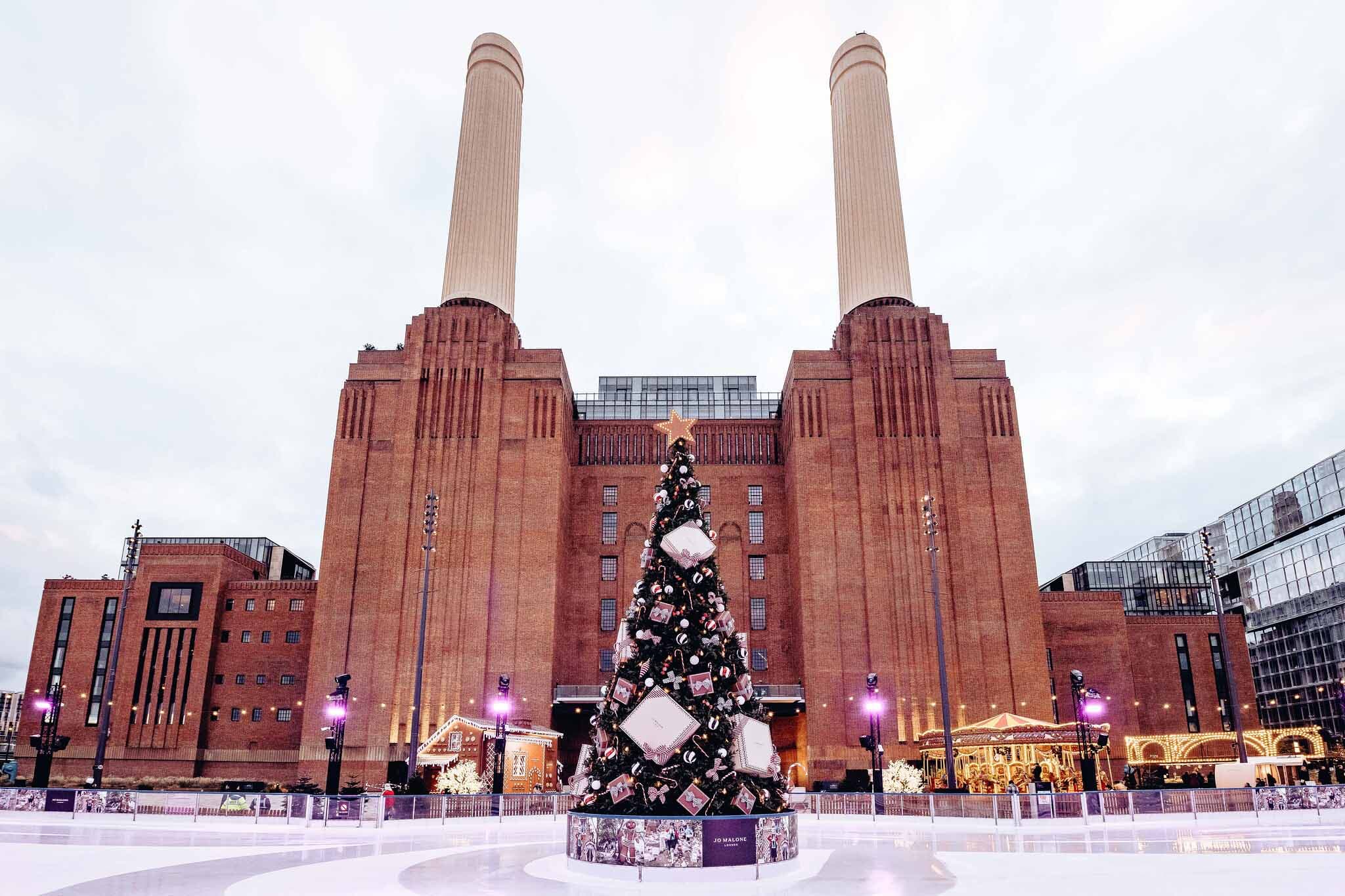 Battersea Power Station with a Christmas tree in front of it