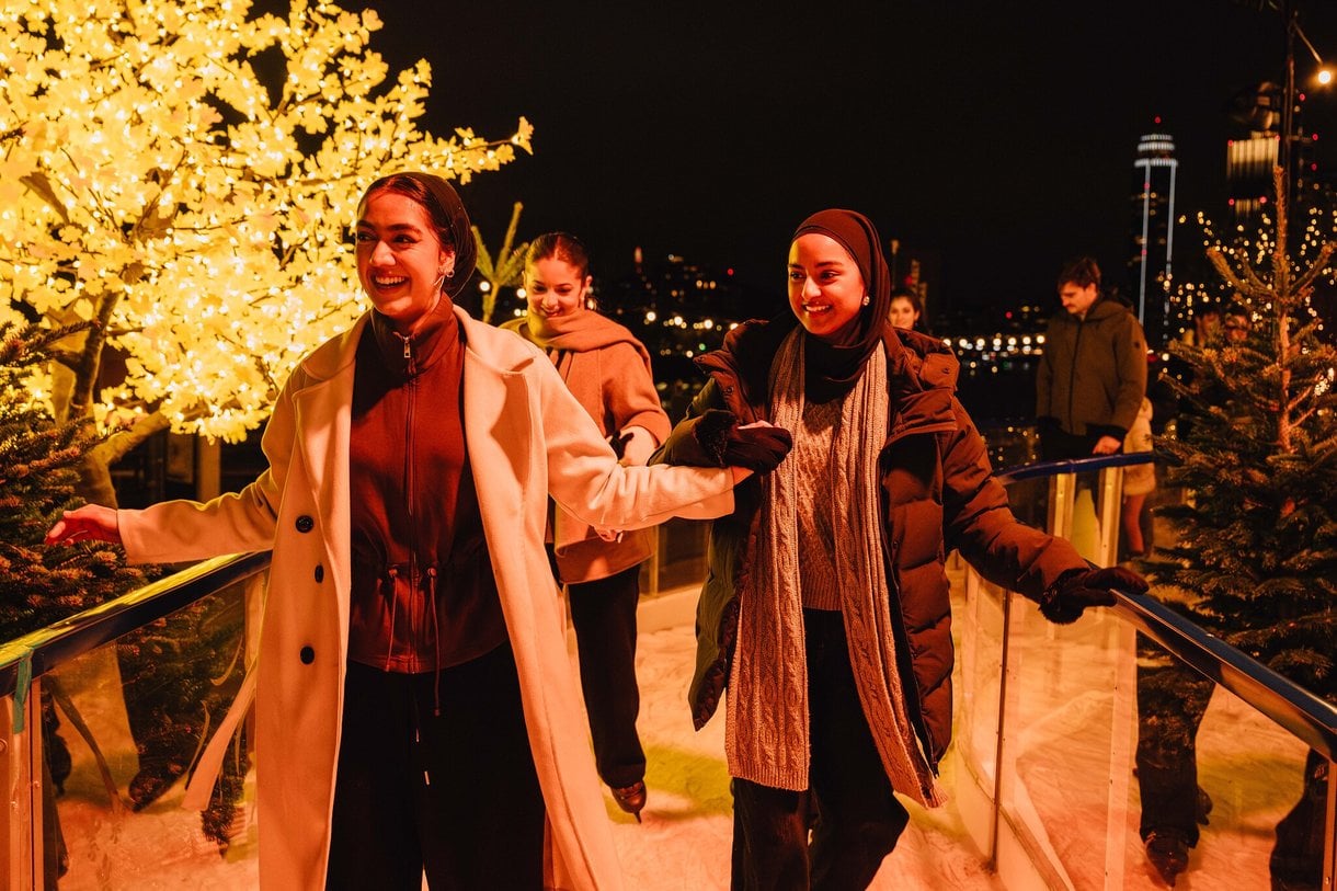 Group of friends laughing and skating on the skate trail together