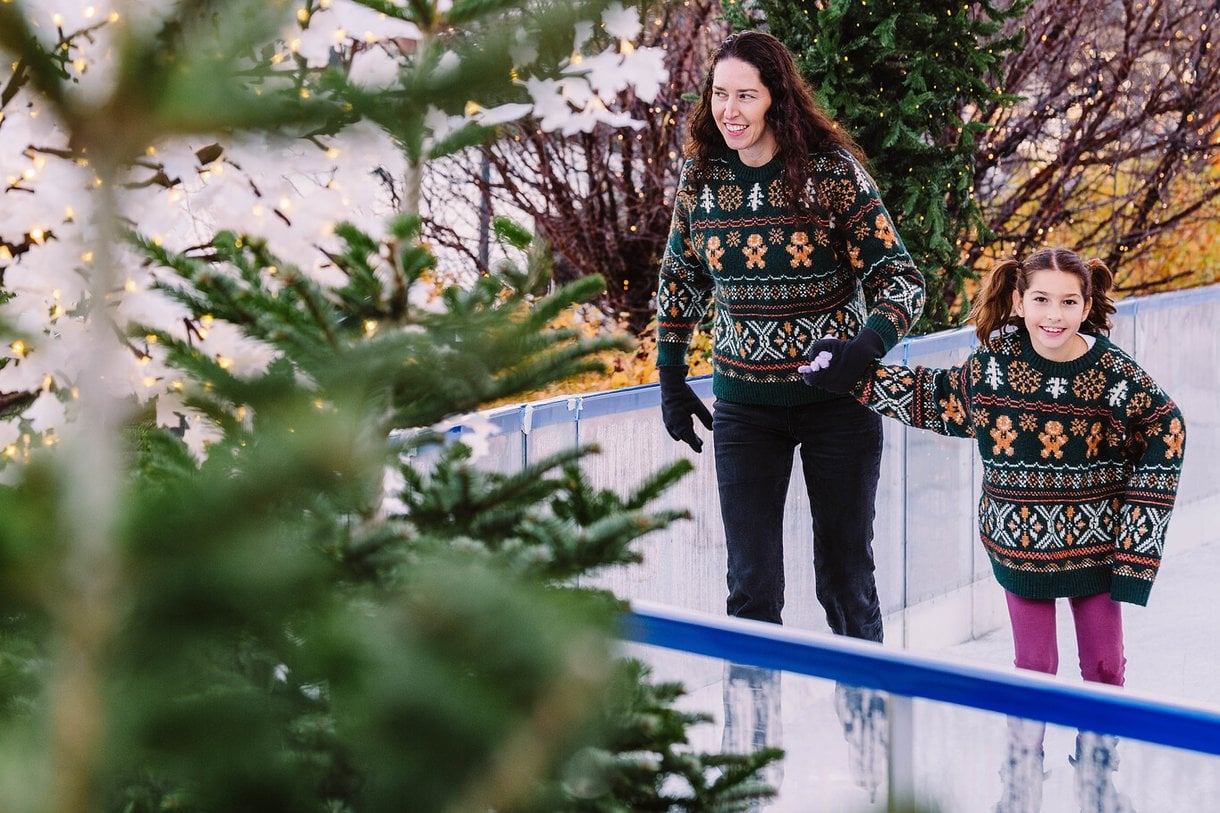 Mum and daughter skating together whilst holding hands