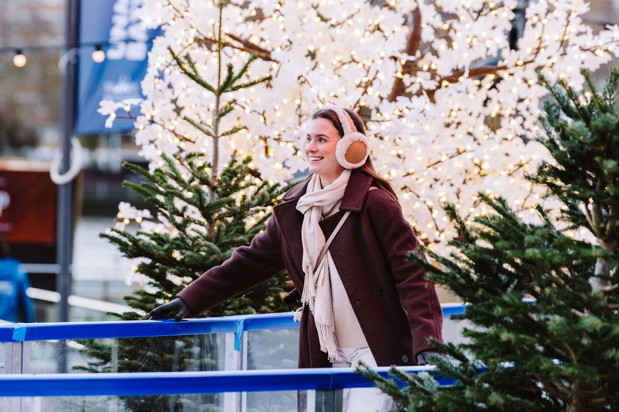 Woman smiling whilst skating on skate trail