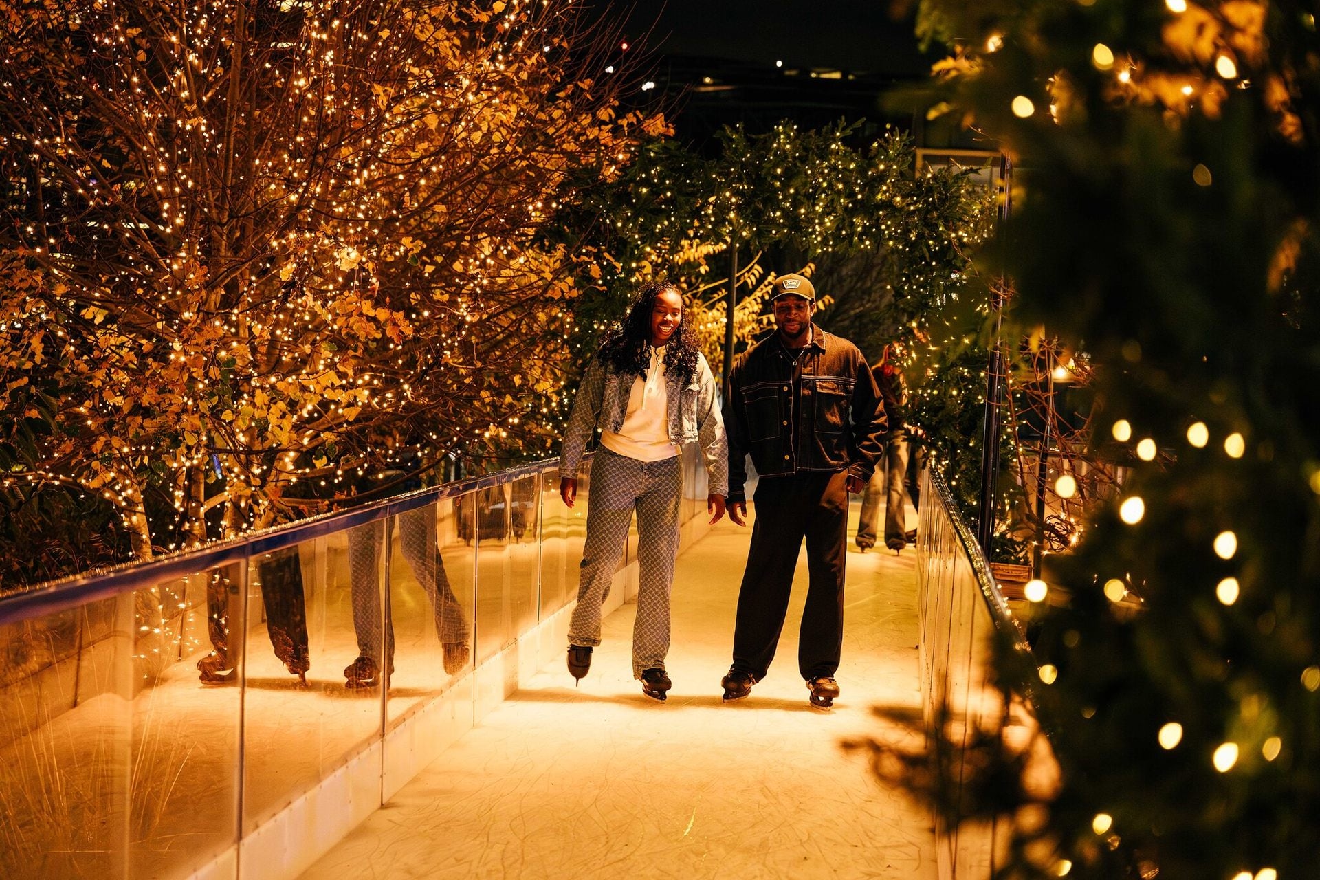 Two people ice skating on skate trail